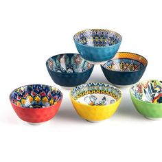 six colorful bowls with designs on them sitting in a circle together and one is empty