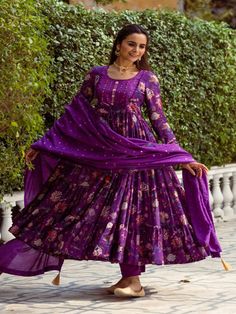 This Set Has a Anarkali, bottom and dupatta. Floral printed tier Anarkali set with hand embroided yoke. It is paired with matching chanderi foil print dupatta enhanced with fabric detailing and palazzo pants. Color: Purple Fabric: Anarkali - Cotton Silk Bottom - Shantoon Dupatta - Chanderi Product Details: Neck Type - Round neck Anarkali Length - 50 inches Bottom Length - 38-40 inches Sleeve Length - 22 inches Note: Available in other colors The product will be delivered within 2-4 weeks of orde Chanderi Sets With Printed Motifs, Floor-length, Designer Cotton Silk Anarkali Set With Printed Motifs, Chanderi Anarkali Set With Printed Motifs For Diwali, Festive Cotton Silk Sharara With Printed Motifs, Diwali Chanderi Anarkali Set With Printed Motifs, Festive Printed Motifs Anarkali Set For Diwali, Festive Anarkali Set With Printed Motifs For Diwali, Diwali Anarkali Set In Mulmul With Printed Motifs, Diwali Mulmul Anarkali Set With Printed Motifs