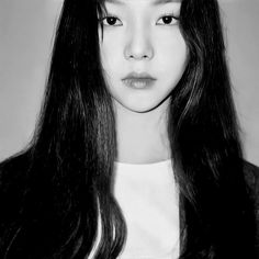 black and white photograph of a woman with long dark hair wearing a crown on her head