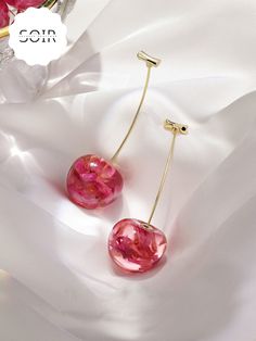 Embrace nature’s beauty with a twist of fun in the FloraCherry Botanical Drop Earrings. These stunning earrings feature long, dangling cherry motifs, each with a glossy red resin "cherry" encasing delicate dried flowers within. The natural blooms are perfectly preserved, adding a touch of earthy elegance to the playful design. Finished with sleek green stems, these earrings are a unique blend of botanical charm and vibrant style, making them the perfect statement accessory for any look. Lightwei Elegant Cherry Colored Jewelry For Party, Cherry-colored Jewelry For Valentine's Day Party, Cherry Color Jewelry For Valentine's Day Party, Cherry Jewelry For Valentine's Day Party, Cherry Colored Jewelry For Valentine's Day Party, Trendy Cherry-colored Earrings, Trendy Red Resin Earrings, Cherry Colored Earrings Gift, Summer Gift Cherry Earrings