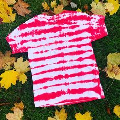 "\"Candy Cane\" Stripped Tie Dye T-Shirt This is the perfect holiday T-Shirt. Great to layer under a sweater, or blazer or by itself. It's perfect the holiday gathering, even family christmas photo's. All items are one of a kind, and made to order. There will be variations in your custom piece. T-Shirt is made of 100% cotton and are unisex sizing. These are true to size, therefore for a looser fit, I recommend sizing up. All orders are typically ready to ship out within 1-2 weeks. Check us out o Unisex Red Cotton T-shirt, Relaxed Fit Short Sleeve T-shirt For Holiday, Red Crew Neck Top For Holiday, Red Crew Neck Holiday Top, Casual Red Christmas Tops, Fun Red Crew Neck Tops, Unisex Pre-shrunk Red T-shirt, Red Unisex Short Sleeve Top, Unisex Red Cotton Tops