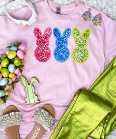 Introducing our "Faux Sequin Bunny Peeps Graphic Shirt," the perfect choice for adding a touch of Easter charm to your wardrobe without the hassle of real sequins. This shirt features a delightful graphic design with faux sequin bunny peeps in pink, blue, and lime, capturing the playful spirit of the holiday.
Please note that this design does not include real sequins, so there is no sparkle, shine, or shimmer. Instead, the faux sequins provide a vibrant and colorful appearance that is perfect for celebrating Easter in style.
Available in sizes ranging from YXS to 5XL, everyone can enjoy the festive charm of this Easter shirt. Whether you're participating in egg hunts, attending family gatherings, or simply spreading holiday cheer, our "Faux Sequin Bunny Peeps Graphic Shirt" is sure to make Spring Glitter Tops, Spring Crew Neck T-shirt With Sequins, Spring Sequined Crew Neck T-shirt, Spring Sequins Crew Neck T-shirt, Spring T-shirt With Glitter Print, Pink Sequined Short Sleeve T-shirt, Casual Pink Sequined T-shirt, Spring Crew Neck Tops With Glitter Print, Spring Crew Neck T-shirt With Glitter Print