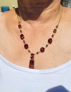 "Oregon Sunstone and Montana Sapphire custom designed Necklace.  This is one of a kind piece, it can never be copied.  There is 34+ carats of Concave faceted Oregon Sunstones.  The main stone is 11.25 cts, the oval stone is 5.5 cts, 4 round 10mm stones 3.40 each and 2 round 8mm stones that are 2.10 cts each.  If you have looked at this necklace before, please note that we changed the Oval stone, it is now a deeper and brighter red. There are 8 Montana Sapphires that are 4mm each for a TCW 2.50.  These are extremely nice Blue Sapphire from Gem Mountain.   Set in 14 kt yellow gold.  The total length o the necklace is approximately 20\" We realize this is an expensive purchase.  We will provide more pictures if needed and can supply a certificate of authenticity from our shop. The sunstones a Costume Jewelry Necklace With Gemstone Accents As Gift, Costume Jewelry Necklace With Gemstone Accents For Gift, Red Stone Necklace For Formal Occasions, Red Stone Necklaces For Formal Occasions, Formal Red Stone Necklaces, Crystal Necklace With Gemstone Accents For Gift, Elegant Amber Crystal Necklace With Stones, Fine Jewelry Red Necklaces With Gemstone Accents, Exquisite Red Jewelry With Gemstone Accents