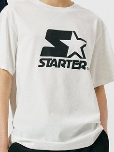 This is a trendy and unique t-shirt by STARTER that is made out of high quality and sturdy material. With distinctive mood of the design and comfortable wear, you can style it for your casual daily outfit.- Woven logo labels detail- Round ribbed neckline- Logo artwork print on the front Casual Short Sleeve T-shirt With Star Logo, Casual Summer T-shirt With Star Logo, Summer Streetwear T-shirt With Star Logo, Casual Tops With Star Logo For Streetwear, Casual Tops With Star Logo And Relaxed Fit, Relaxed Fit Tops With Star Logo For Streetwear, White Star Logo Top For Streetwear, Casual T-shirt With Star Logo For Streetwear, White Tops With Star Logo For Streetwear