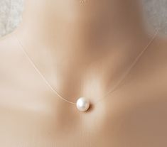 Genuine Cultured Freshwater Pearl Floating Illusion Necklace Stunning and simple will suit all occasions..  9-10mm very good lustre freshwater pearl on good quality jewellery illusion cord with 14ct gold filled clasp The pearls are genuine freshwater pearls therefore each pearl is slightly different in shape and size and each pearls has its own natural unique blemishes.  Will be sent in a organza gift bag All measurements mentioned in this listing is Approximately  Please note the colour of the Elegant Single Strand Clear Necklace, Clear Pearl Jewelry As A Gift, Pearl Jewelry For Gifts, Clear Pearl Jewelry For Gifts, Necklace Transparent, Illusion Necklace, White Freshwater Pearl, Wedding Jewellery Necklace, Pearl Pendant Necklace