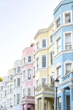 a row of multi - colored houses in the city