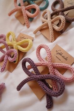 several different colored bows are tied together on brown paper and placed next to each other