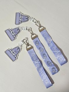 four blue lanyards with cartoon characters on them