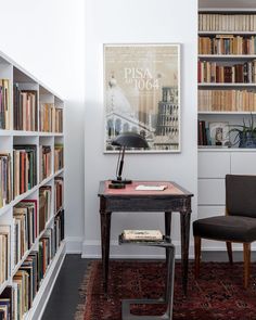 a chair and table in front of bookshelves