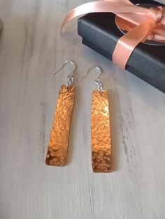 ~ LONG COPPER AND SILVER DANGLE EARRINGS ~ These pretty earrings are handmade and unique. I cut the rectangles from pure copper sheet and filed the edges, then flattened with a raw-hide mallet. Made holes with a metal hole punch. Then I textured with a repoussé for the hammered effect, allowing the copper to shine through. Finally I polished them in a natural organic solution. The ear wires are 925 hallmarked and all other silver components are also sterling. These are statement earrings and ide Rectangular Rose Gold Earrings For A Gift, Rectangular Copper Earrings With Ear Wire, Handmade Rectangular Copper Earrings, Hammered Brown Jewelry For Gift, Nickel-free Rectangular Copper Jewelry, Brown Hammered Jewelry For Gift, Brown Hammered Jewelry As A Gift, Artisan Rectangular Earrings As Gift, Artisan Rectangular Earrings For Gift