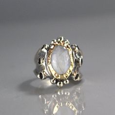 "Moonstone Ring, Garnet Ring, 9K Yellow Gold Hammered Queen Ring in Sterling Silver Band, Gemstone Ring, Antique Style Ring, Chunky Ring This garnet and moonstone ring looks like it was made for a queen. It is ornate but delicate, statement piece but not oversize. The band is adjustbale to any finger size and made of sterling silver set with dark red natural garnet gemstone. The center is a bezel set moonstone gemstone and 9K solid gold, welded on sterling silver, hammered around the moonstone. Luxury Oval Moonstone Anniversary Ring, Heirloom White Moonstone Ring With Rose Cut Diamonds, Luxury Moonstone Gemstone Ring For Anniversary, Unique Oval Moonstone Ring In Yellow Gold, Unique Oval Yellow Gold Moonstone Ring, Unique Yellow Gold Oval Moonstone Ring, Heirloom White Gold Moonstone Ring, White Multi-stone Moonstone Ring Fine Jewelry, Yellow Gold Oval Moonstone Ring In Sterling Silver