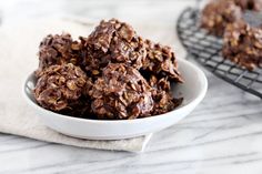 a white bowl filled with chocolate covered cookies