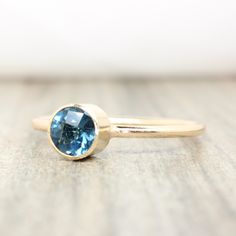 Genuine London Blue Topaz Stacking Ring made with 14K gold filled. Also available in .925 sterling silver. Crafted with love and attention to detail, these rings are made of high-quality 14k gold filled with a beautiful finish. They effortlessly blend durability with a refined aesthetic, ensuring they will be cherished for years to come. 💛 The colors will not chip off or fade and can be worn in water. This ring is made to order in your size. If you don't see your size available please feel free Dainty 14k Gold Topaz Birthstone Ring, Minimalist Topaz Birthstone Ring, Stackable Blue Topaz Birthstone Ring Gift, Everyday Round Cut Gemstone Birthstone Ring, Minimalist Topaz Gemstone Ring For Everyday Wear, Everyday Blue Sapphire Ring In 14k Gold, Minimalist Topaz Ring For Everyday, Minimalist Topaz Birthstone Jewelry, Stackable Blue Topaz Birthstone Ring