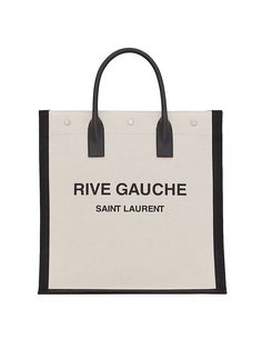 Find SAINT LAURENT Rive Gauche Tote Bag on Editorialist. The Saint Laurent Rive Gauche Tote Bag is crafted entirely of canvas and features a two-tone motif. The bag is styled with the words 'Rive Gauche', a reference to the southern bank of the river Seine in Paris. It has dual top handles and is made in Italy. Saint Laurent Rive Gauche Tote, Saint Laurent Tote, Saint Laurent Jeans, Saint Laurent Boots, River Seine, Logo Wear, Rive Gauche, Chanel Deauville Tote Bag, Saint Laurent Bag