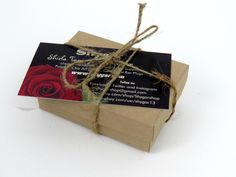 a package wrapped in brown paper and tied with twine, sitting on a white surface