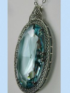 Sky Blue Aquamarine Pendant, large sky blue gem oval pendant with sterling silver art deco filigree, Silver Embrace Jewelry Elegant Light Blue Oval Necklaces, Blue Pendant Necklace For Evening, Elegant Blue Filigree Necklace, Blue Art Deco Necklace For Formal Occasions, Victorian Blue Gemstone Necklace, Vintage Blue Diamond Cut Jewelry, Vintage Blue Jewelry With Diamond Cut, Blue Vintage Jewelry With Diamond Cut, Ornate Blue Necklace With Intricate Design