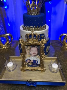 a blue and gold cake with a photo on it