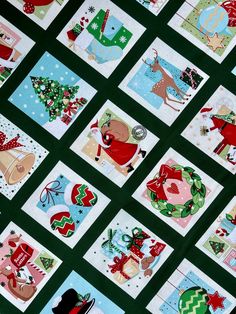 many christmas cards are arranged on a green tablecloth with red, white and blue designs