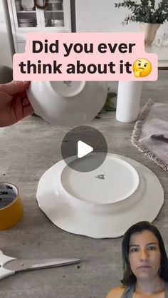 a woman standing in front of a white plate on top of a table next to other plates