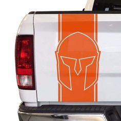 an orange and white truck with a spartan helmet on it's tailgates