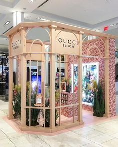 a gucci bloom store in the middle of a shopping mall with its doors open