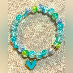 This Listing Is For One “Teal And Yellow Crackle Beaded Heartbracelet” -Made With 8mm Acrylic Crackle Color Beads, A 6mm Rose Gold Crystal Rhinestone Spacer Bead And Teal Heart Charm Strung On A Clear Elastic Stretch Cord. -Light In Weight, Smooth Surface And Exquisite In Appearance, Not Easy To Fade Or Break And Durable Enough To Wear Daily - I Highly Recommend Measuring Your Wrist With String & Choose A Size 1/4”-1/2” Larger Than Your Wrist Depending On How Snug You Want Your Bracelet To Fit. Trendy Turquoise Round Beads, Green Jewelry With Heart Charm And Round Beads, Turquoise Heart-shaped Beaded Bracelet, Turquoise Bracelets With Heart Beads For Jewelry Making, Turquoise Heart Beads For Jewelry Making, Casual Jewelry With Heart Charm And Round Beads, Casual Handmade Heart Bracelet With Round Beads, Trendy Blue Heart-shaped Bracelet, Blue Beaded Bracelets With Heart Charm For Gift