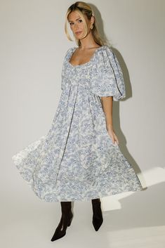 the search for the perfect all-season wedding guest dress is over. this stunning puff sleeve midi dress features a blue floral pattern + a flirty corset-inspired bodice. guaranteed to turn heads with every wear, it’s a must-have for cocktail parties, holiday dinners, or anytime you feel like frolicking. blue floral // midi length, scoop neckline, dramatic puff sleeves, back zipper closure, smocked bodice, fully lined model is 5'8" + wearing a small measurements are approximate + taken while layi Blue Floral Print Midi Dress With Puff Sleeves, Blue Floral Print Puff Sleeve Midi Dress, Blue Floral Print Midi Length Puff Sleeve Dress, Floral Print Midi Puff Sleeve Dress For Garden Party, Garden Party Floral Print Midi Puff Sleeve Dress, Blue Midi-length Puff Sleeve Dress With Smocked Bodice, Floral Print Puff Sleeve Midi Dress, Puff Sleeve Midi Dress With Floral Print For Brunch, Brunch Floral Print Midi Dress With Puff Sleeves