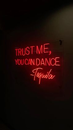 a neon sign that says trust me, you can dance tequila in spanish and english