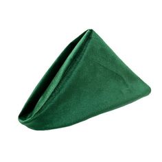 a green velvet napkin folded in the shape of a triangle