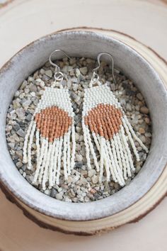 "These hand beaded earrings are made with delica seed beads in cream and pumpkin colors. Hanging from silver colored ear wires, they measure 3\" in length. Hand woven with durable high quality thread!" Artisan White Earrings With Beaded Fringe, White Beaded Fringe Jewelry For Crafting, Beaded Beige Dangle Jewelry, Natural Beaded Dangle Jewelry, Natural Color Beaded Dangle Jewelry, White Handwoven Drop Earrings, Beige Beaded Dangle Jewelry, White Artisan Beaded Dangle Earrings, White Handwoven Earrings For Summer