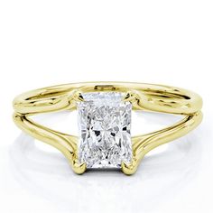 a yellow gold engagement ring with a princess cut diamond in the center and twisted band