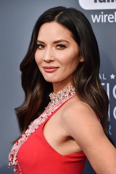 a woman in a red dress posing for the camera