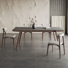 a dining table with four chairs around it