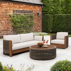 an outdoor living area with couches and tables