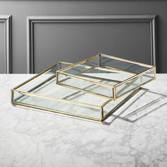 three glass trays sitting on top of a marble counter