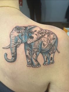 an elephant tattoo on the back of a woman's upper arm and shoulder,