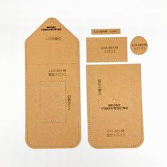 two pieces of brown paper with white stitching on them and tags attached to each other