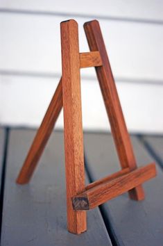 a small wooden easel sitting on top of a table