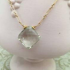 This is a pretty necklace that looks good with a black top or a "power" suit. It looks great on all complexions. The gemstones are AAA in quality. Stunning prasiolite (green amethyst) pendant, measuring 23mm x 23mm. The prasiolite pendant is cushion cut and transparent. The pendant hangs from a 14K GF chain, adorned with 6mm fuchsia rondells. Elegant Green Gemstone Crystal Necklace, Elegant Faceted Green Amethyst Jewelry, Elegant Faceted Necklace For Everyday Wear, Elegant Green Amethyst Jewelry For Gifts, Elegant Yellow Gold Crystal Necklace With Gemstone, Elegant Everyday Amethyst Necklace, Elegant Faceted Drop Necklaces, Elegant Amethyst Necklace With Large Stone, Elegant Large Stone Necklace For Anniversary