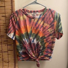 a tie dyed shirt hanging on a wall