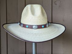 Five large sterling silver Conchos with a pop of color from 6 Kingman Turquoise stones that have set in sterling silver and mounted on new brown rein leather. Secures on your hat with deertan lace and an antler bead slider.The leather band is 3/4" wide and 23" in length.Hat not included. Concho Jewelry For Rodeo, Adjustable Concho Jewelry For Rodeo, Brown Hand Tooled Jewelry For Rodeo, Hand Tooled Brown Jewelry For Rodeo, Adjustable Southwestern Turquoise Hat Bands, Rustic Adjustable Jewelry For Rodeo, Brown Concho Jewelry For Rodeo, Adjustable Brown Hat Band With Concho, Adjustable Brown Western Jewelry