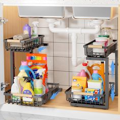 two metal baskets filled with cleaning supplies on top of a counter next to a sink