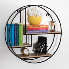 a black metal shelf with books and a camera