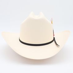 El Clásico 100x Sinaloa straw cowboy hat has a classic cattleman crown with a traditional brim crease & finished with a black 2-ply ribbon hat band. | Sombrero estilo Sinaloa 100x con una copa clásica y ala tradicional terminado con una banda de cinta negra. 4 3/4" crown 3.5" Sinaloa style brim Ribbon band with feather (feather colors vary) Synthetic sweatband Material: Shantung 2x2 weave - Grade 3 Includes brand box Made in Mexico Chapeau Cowboy, Straw Cowboy Hat, Colorful Feathers, Hat Band, Cowboy Hats, Cowboy, Straw, Band, Hats