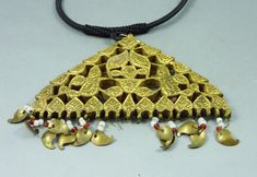 Old pendant from Kashmir made with glass beads set in gilded brass. This type of jewellery is a humble imitation of the Mughal style gold and gemstone jewellery. Small brass pendants in mango shape and translucent glass beads are hanging from the pendant. A few glass beads and mango pendants are missing. From mid XXth Century or older. This is an old and worn item. The pendant is 8,5 cm high with the hanging pendants (3,34 in) and 9,5 cm wide (3,74 in). The black cord is adaptable in size with a Traditional Pendant Jewelry For Puja, Heavy Brass Jewelry For Puja, Brass Chandbali Necklaces For Rituals, Brass Jewelry For Rituals And Festivals, Brass Chandbali Temple Necklace For Festivals, Traditional Kundan Pendant Necklace For Puja, Brass Temple Necklace With Intricate Design For Puja, Traditional Temple Necklace With Pendant For Puja, Heavy Brass Temple Necklace