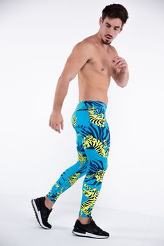 Description: Blue & Green Tiger Print Men’s Performance Leggings Compression Level: Light to Medium Sweat-wicking Poly / Spandex with 4-Way Stretch Bounce-Proof Phone Pocket Zip Pocket For Cash & Keys Ergonomic Waistband Adjustable Drawstring Flat Seams Sports Gusset Embroidered Bolt Logo Machine wash cold, quick drying Model is 6’2’’ (189cm) tall, 34’’ (86cm) waist size and wears size Large. Blue Elastane Training Pants, Blue Fitted Bottoms For Running, Blue Elastane Sportswear Pants, Blue Sportswear Pants For Running, Blue Tight Pants For Training, Tight Blue Training Pants, Summer Gym Blue Leggings, Blue Tight Training Pants, Casual Blue Running Pants