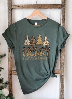 "Christmas Tree Shirt, Leopard Christmas Shirt, Christmas Tree Winter Shirt, Womens Christmas Shirt, Merry Christmas Shirt, Ladies Christmas Please Check All Photos For Details.   🐞Choose Your T-Shirt Size From The Drop-Down Lists Next To The item Picture   ⭐Choose Of Your T-Shirt Color From The 2nd Picture   🐞Use \"Add message to Seller\" link On The Checkout Page To Send me the Following important Details For Your Order's Customization.   ⭐Shipping Time Varies by location (we are located in Sugar Land, Texas) please consider that our turn around time is 1 to 3 business days.     ⭐Which brand do you use for t-shirts? We use Gildan Softstyle, Bella Canvas Unisex, Hanes, Outlash, Tees,  District and Next Level when we have a shortage of stocks for certain colors and sizes. Our printing me Green Christmas Shirt Ideas, Red Green Plaid Holiday Shirt, Womens Christmas Shirts Leapord Print, Relaxed Fit Christmas T-shirt For Holiday, Womens Merry Christmas Tree Sweatshirt, Cheap Women's Christmas T-shirt, Leopard Christmas, Tree Winter, Womens Christmas