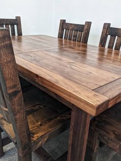 a wooden table with four chairs around it