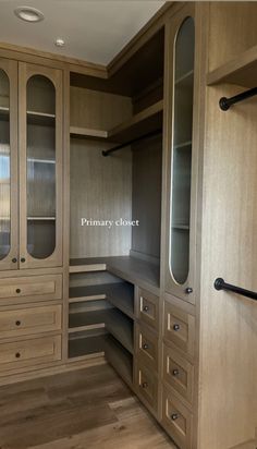 an empty walk in closet with drawers and shelves