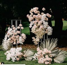 flowers are arranged in vases on the grass